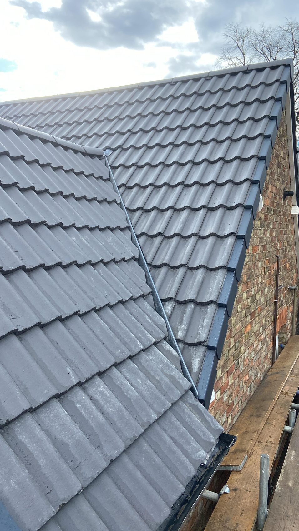 Two re-covered slopes running into a new lead valley, anthracite dry verge on the gable edge