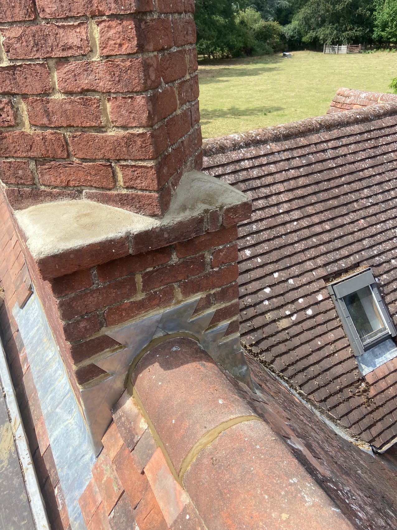 Chimney base, lead flashing and ridge seen in context at survey