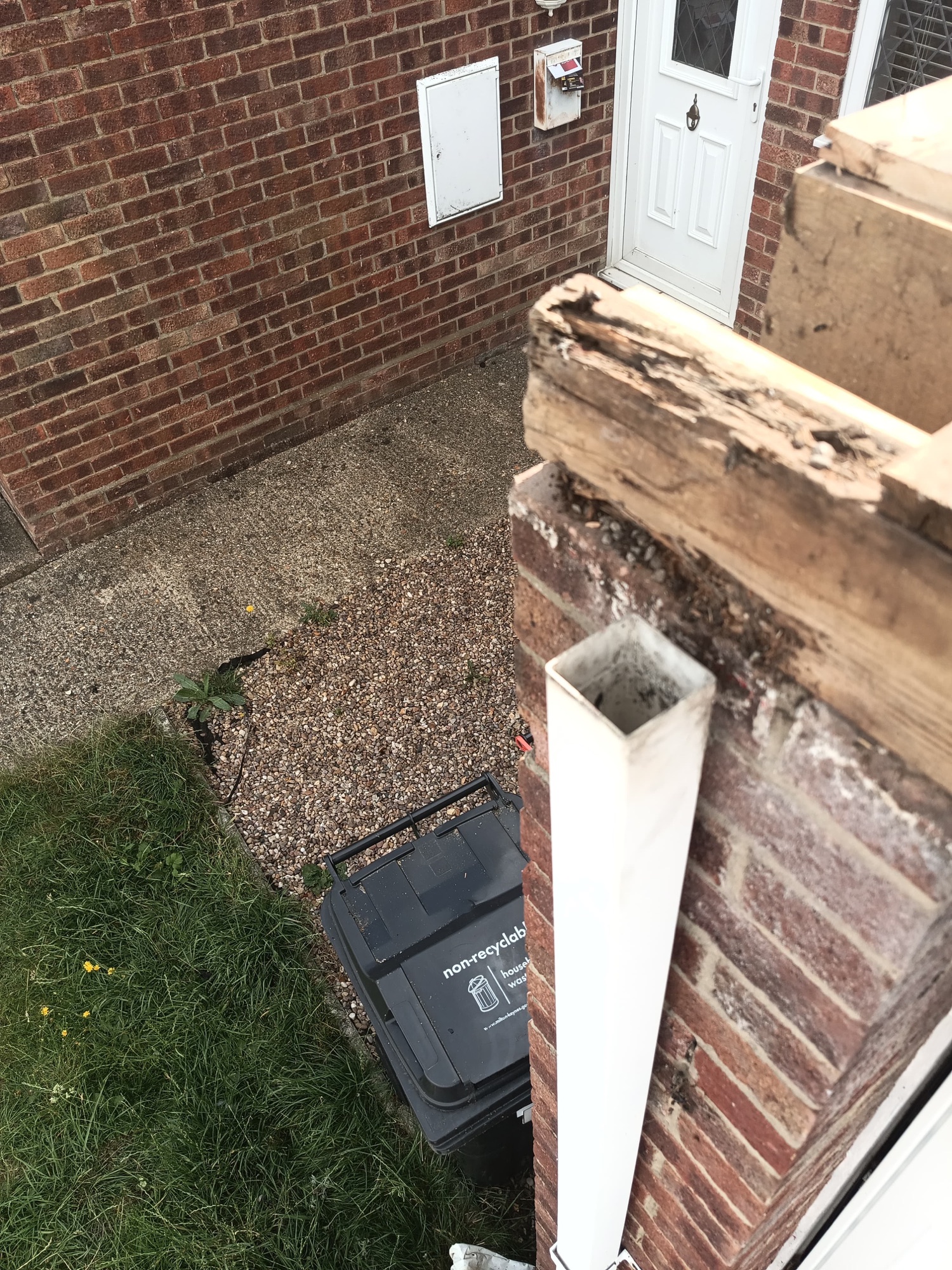 Soft, perished edge timber cut out from the roof edge above the old downpipe