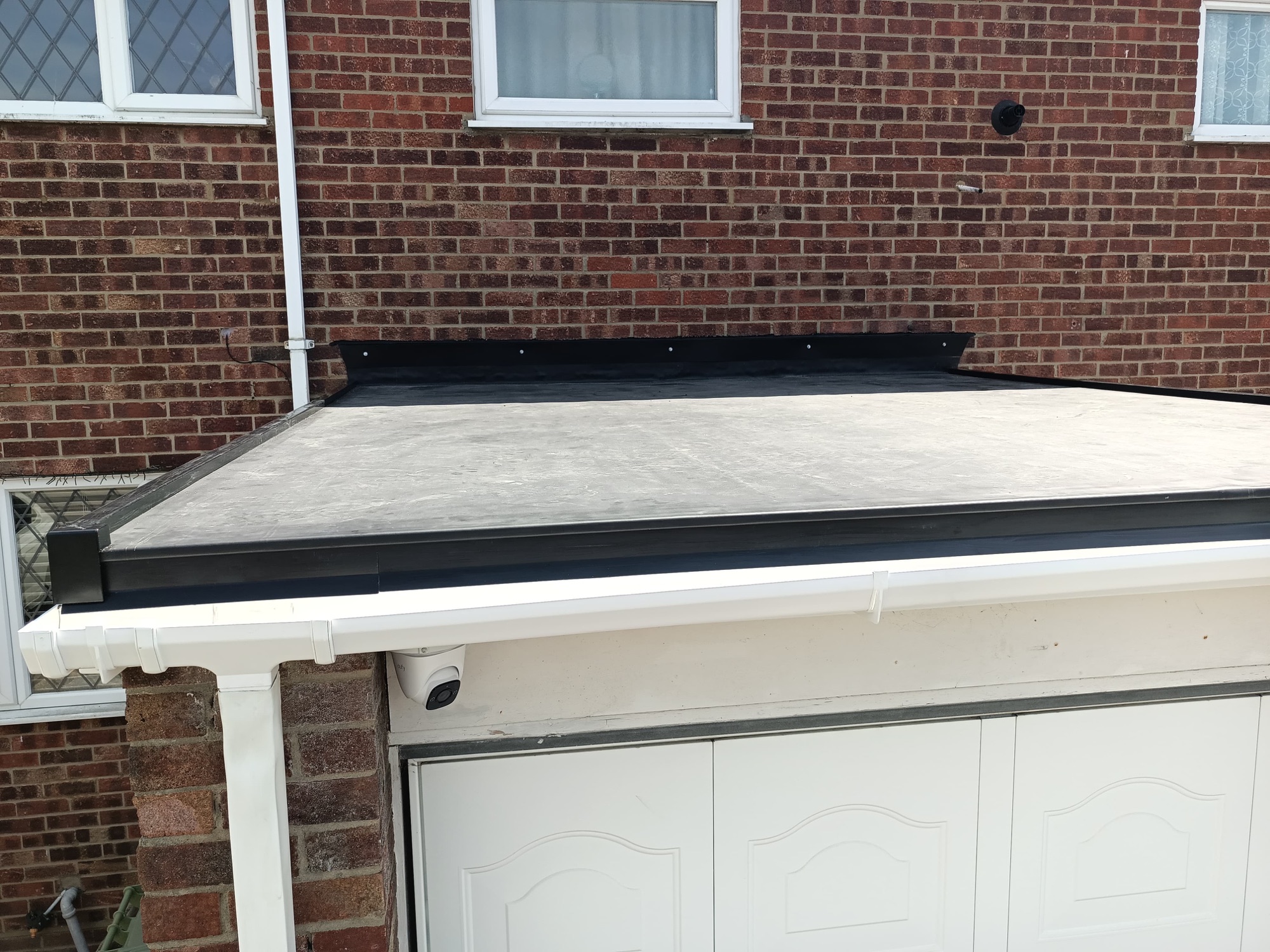 Foxgate finished fibreglass flat roof with new black trim, fascia and gutter