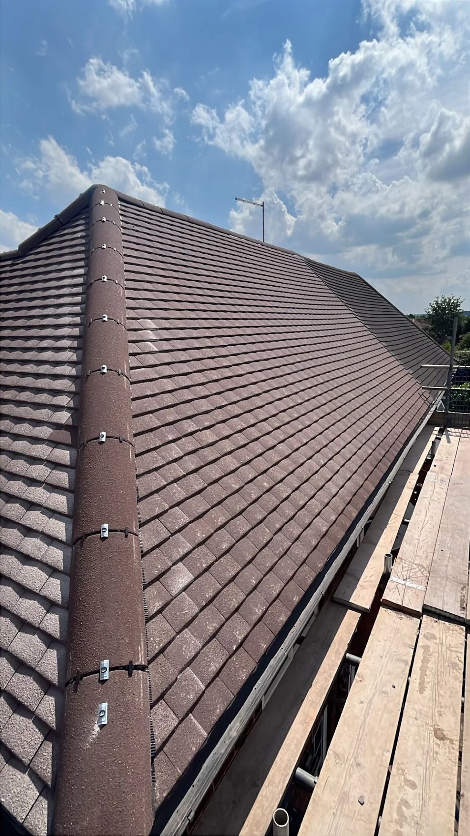 Finished hipped roof re-covered in interlocking tile with a dry-fix hip and ridge