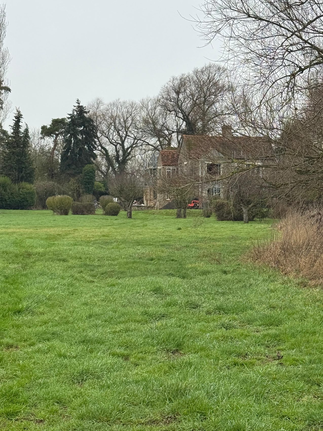 Ravenstone Mill seen from the field on arrival, with its original tiled roof still in place