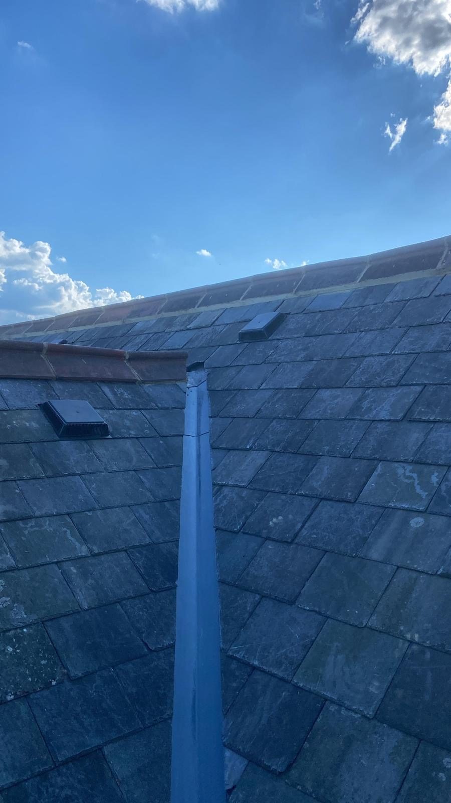 Hand-formed lead valley running down a reclaimed natural slate roof