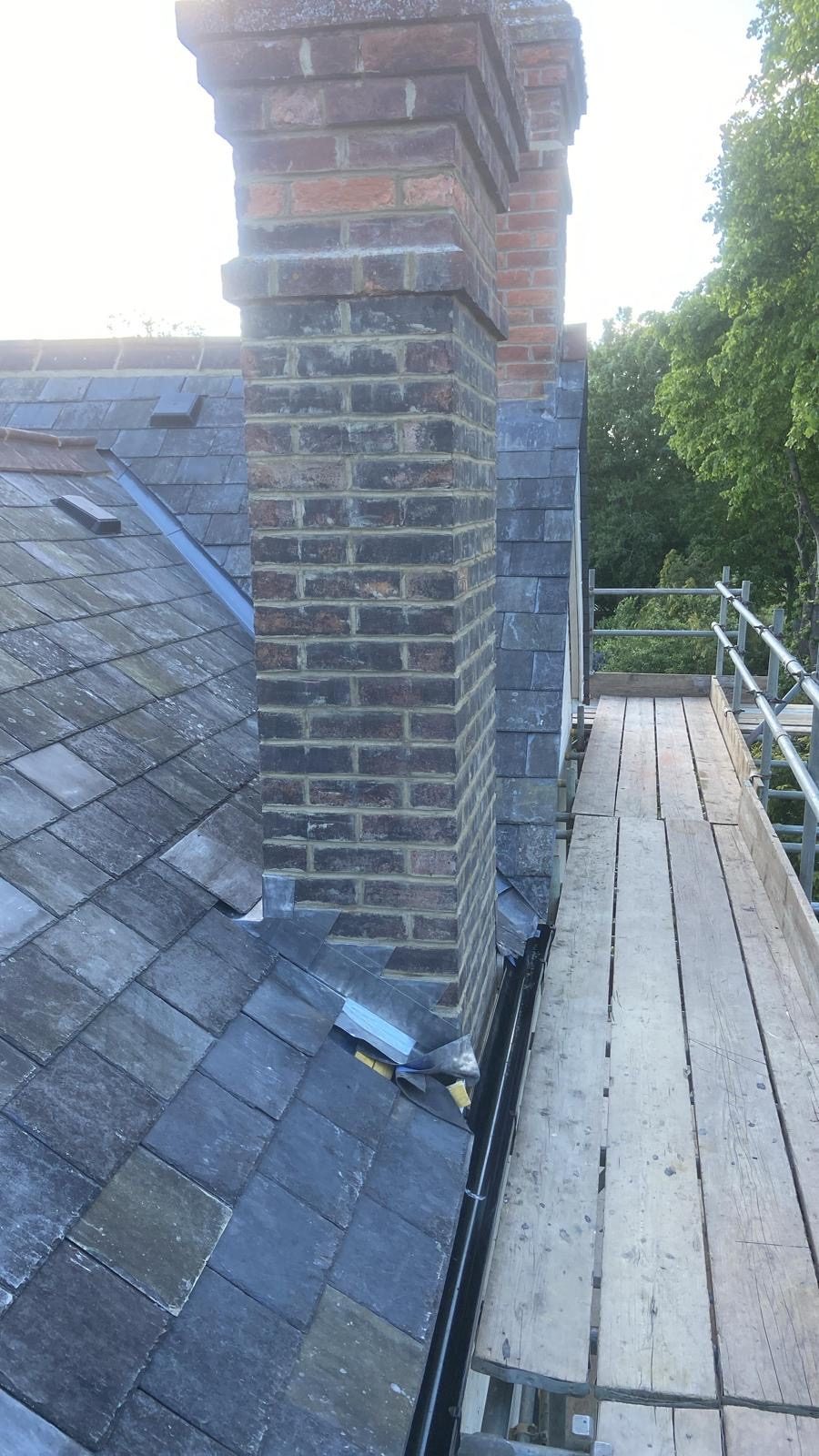 New lead apron dressed around the brick chimney stack