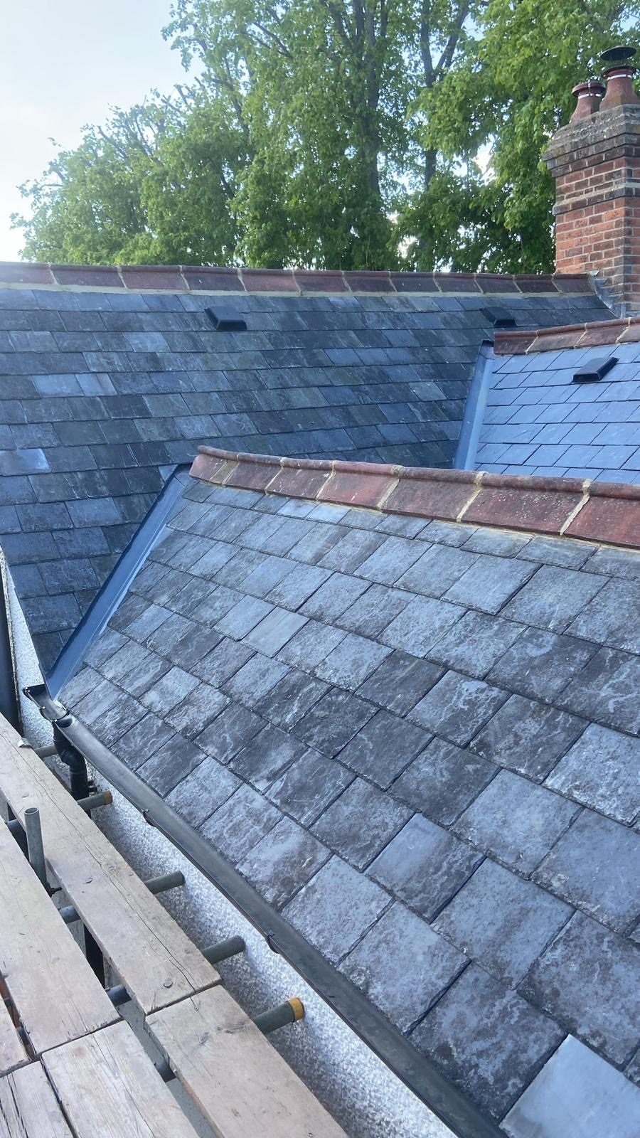 Period roof re-covered in reclaimed natural grey slate with red clay ridge tiles