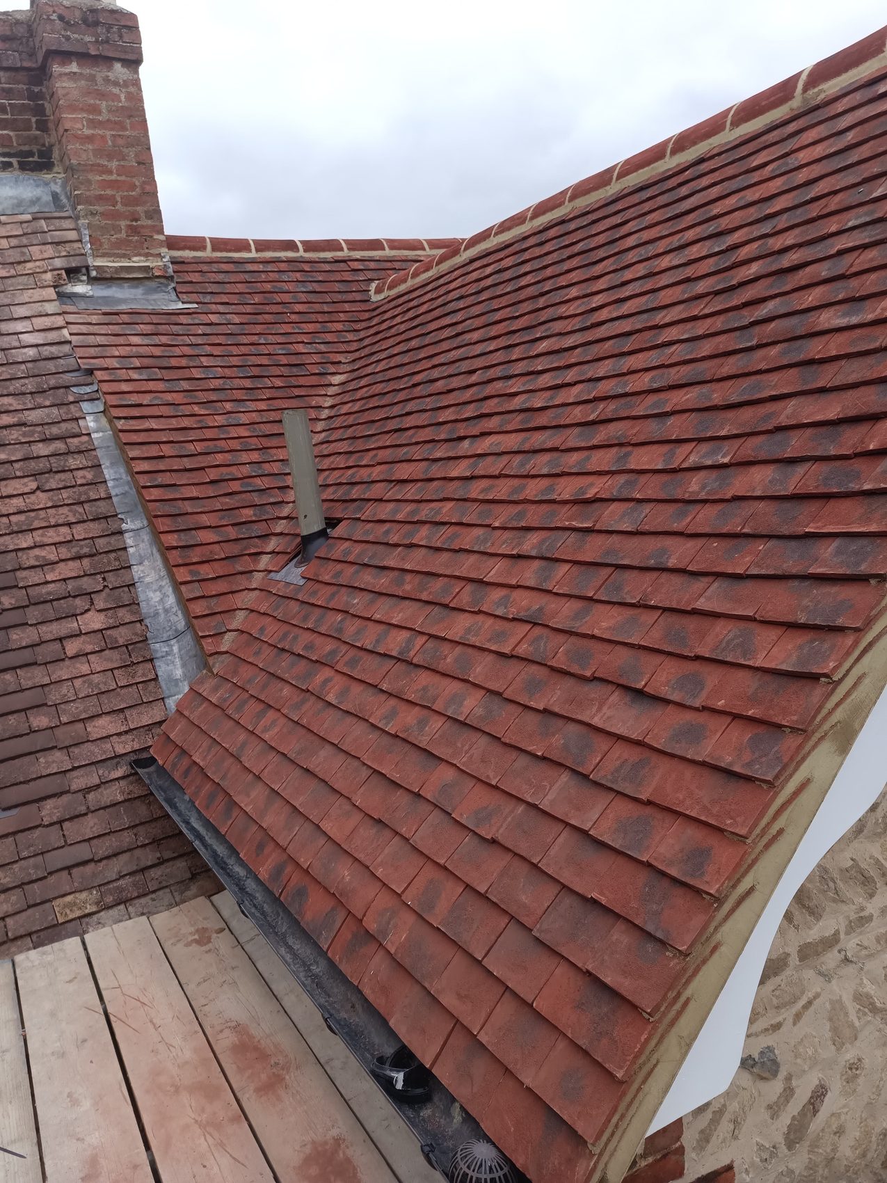 Sherington roof with new plain clay tiles and decorative fascias and soffits