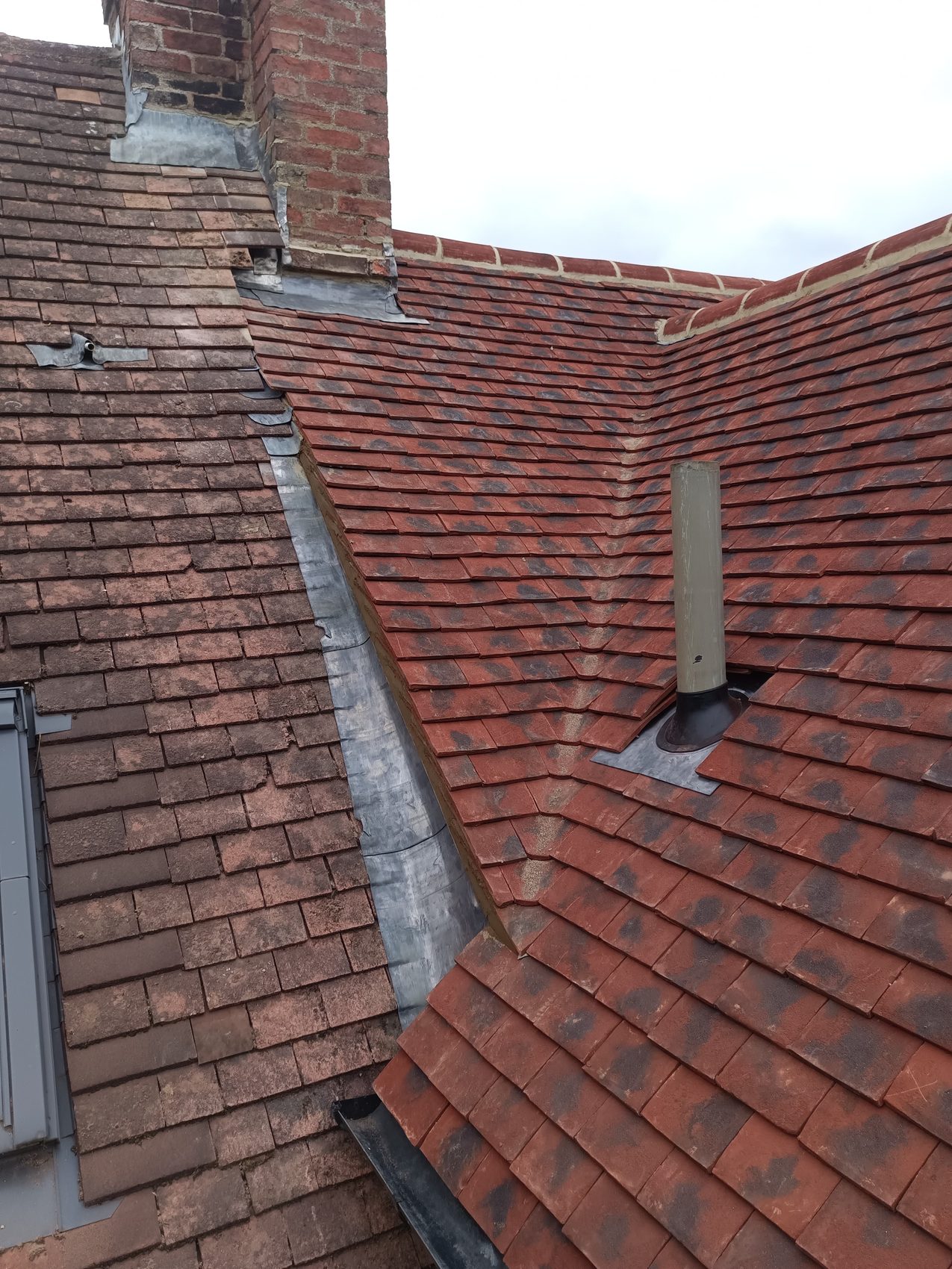 A pitched clay tile roof and ridge line completed by the Clarkson Roofing family team in Sherington