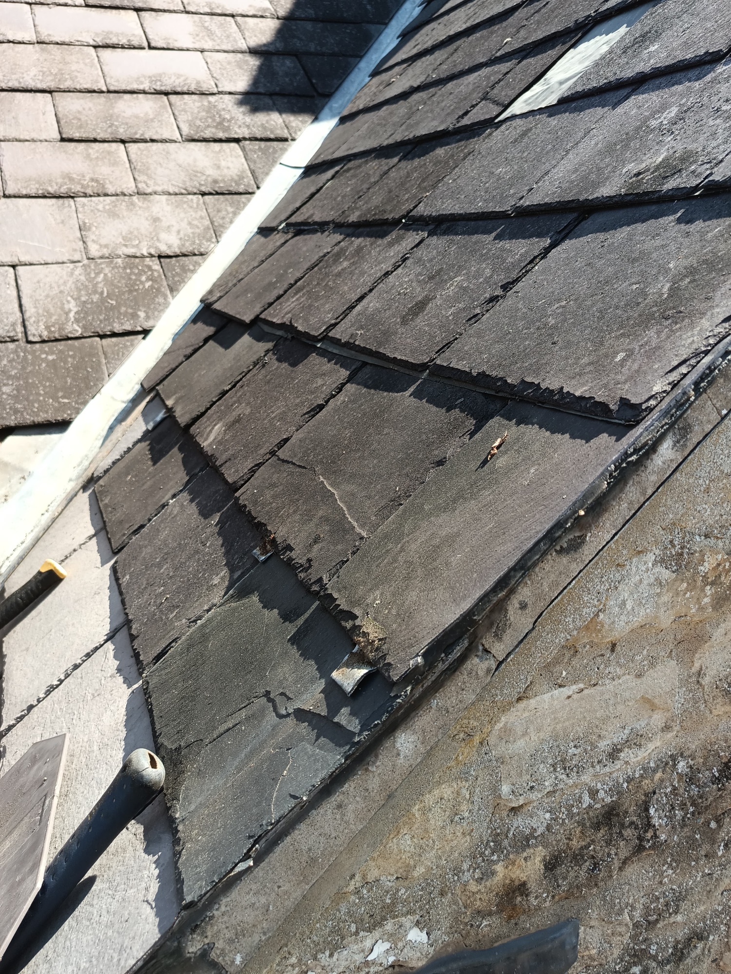 Old failing box gutter between two slate roof pitches before the rebuild