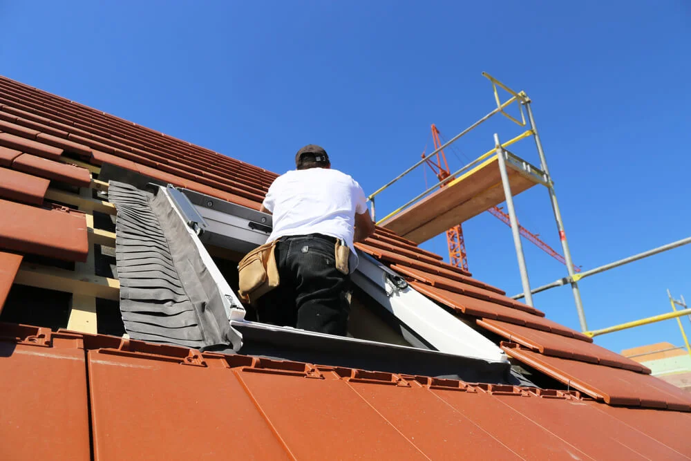 Storm-damaged roof mid emergency repair by Clarkson Roofing.